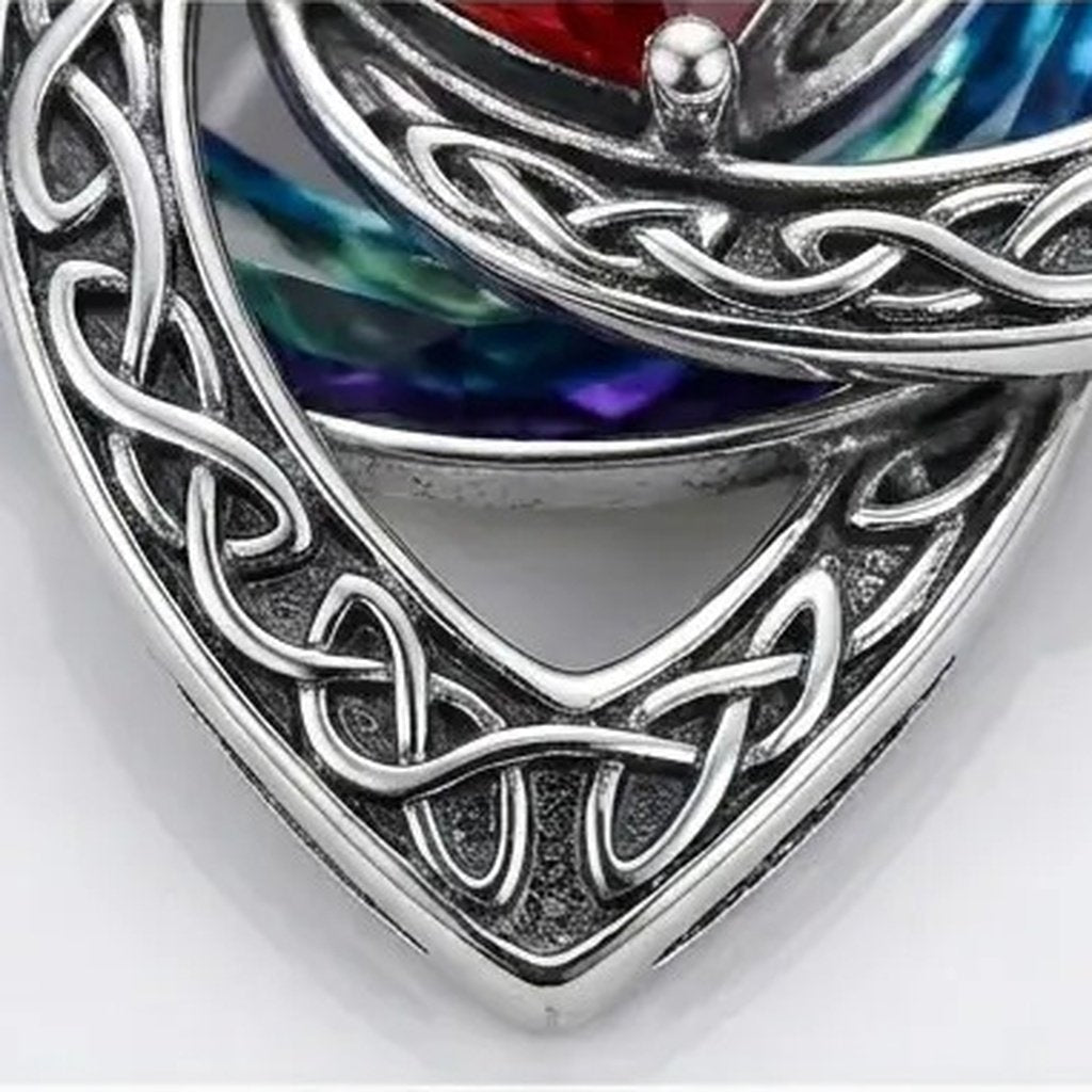 Macro view of the open work silver trinity knot showing the braided texture of the three loops