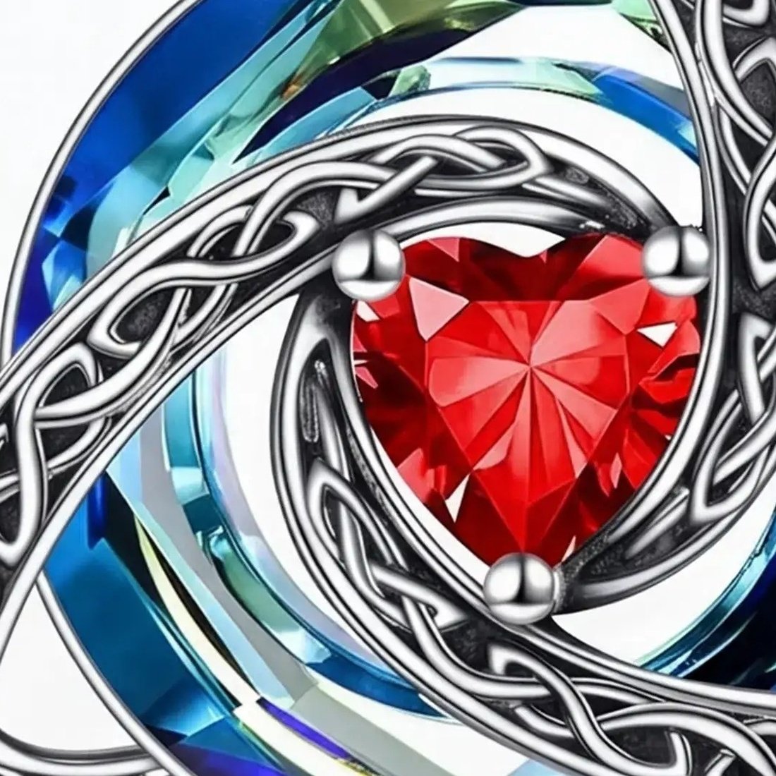 Macro view of the faceted blue to green bicolor crystal swirl behind the knotwork