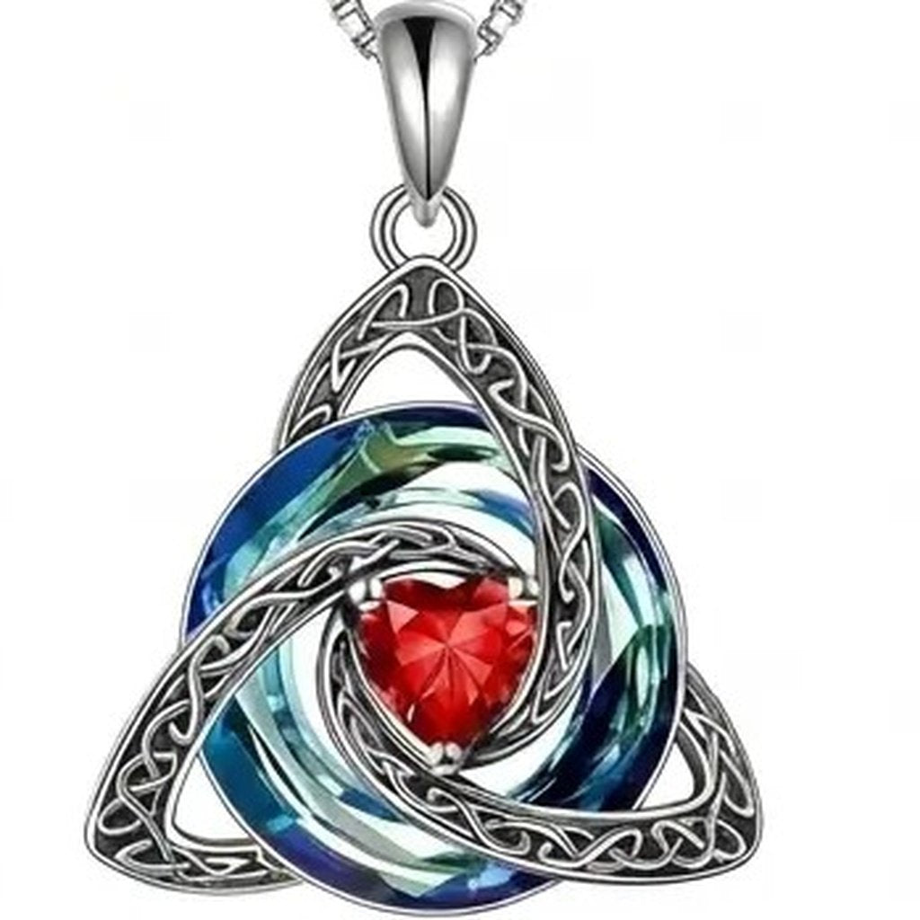Close view of the open work Celtic trinity knot and the blue to green crystal swirl running through it