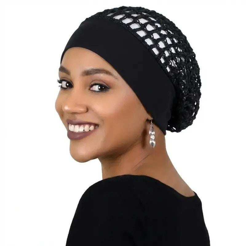 A woman wearing the black Pomence sleeping bonnet