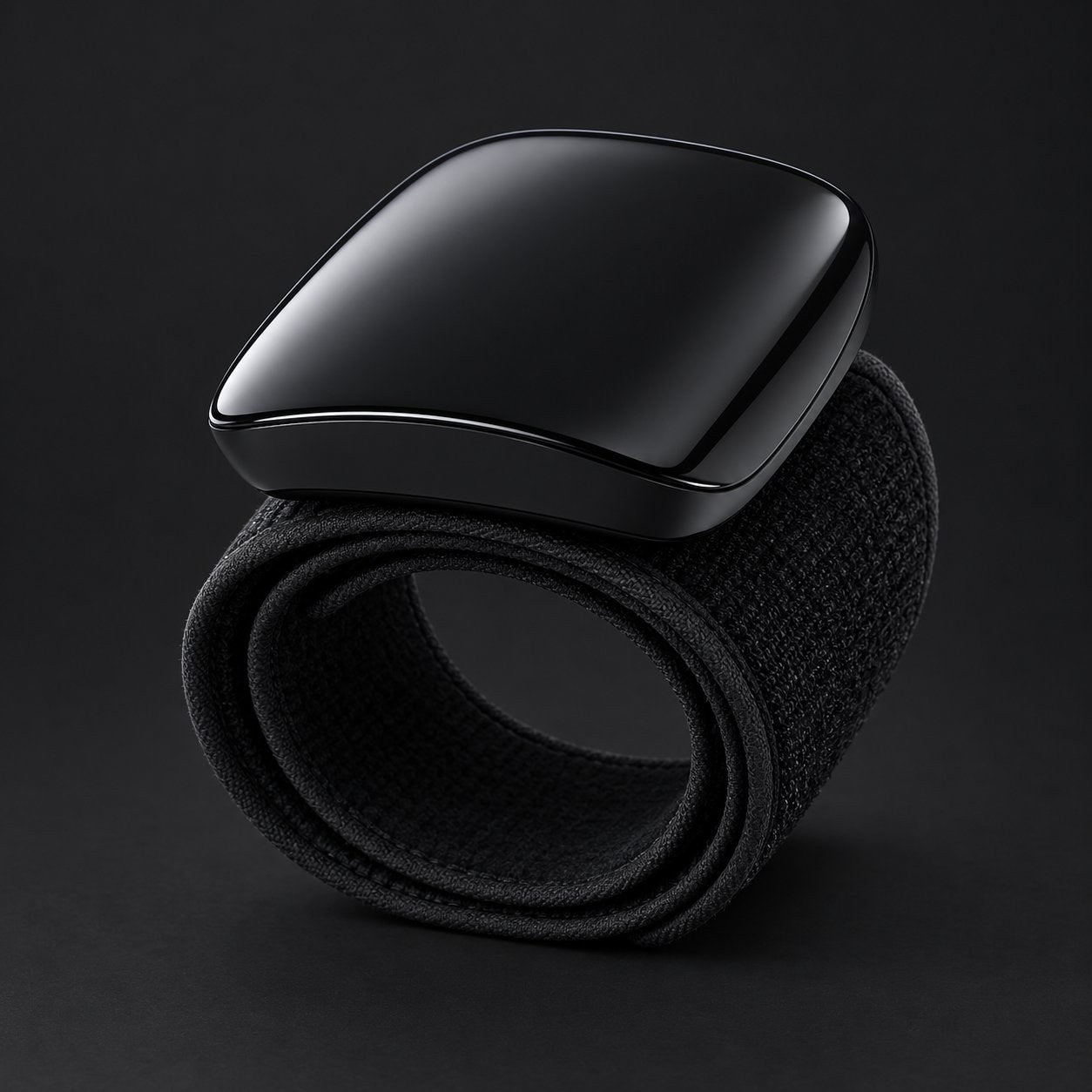 The black Pomence wrist blood pressure monitor alone on a dark ground, band coiled beneath the glossy shell