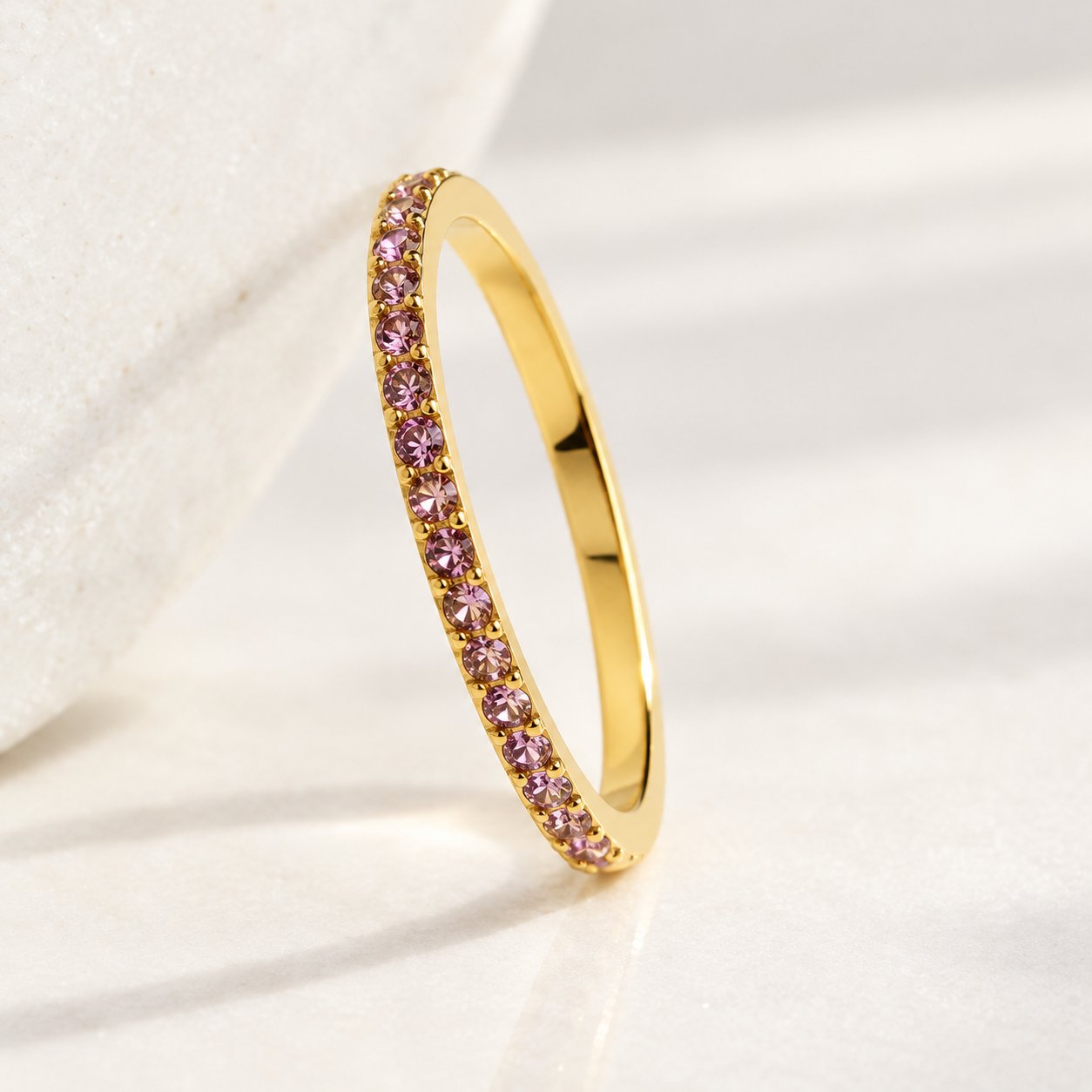 Several Pomence Birthstone Stacking Ring bands in different sizes shown together for scale
