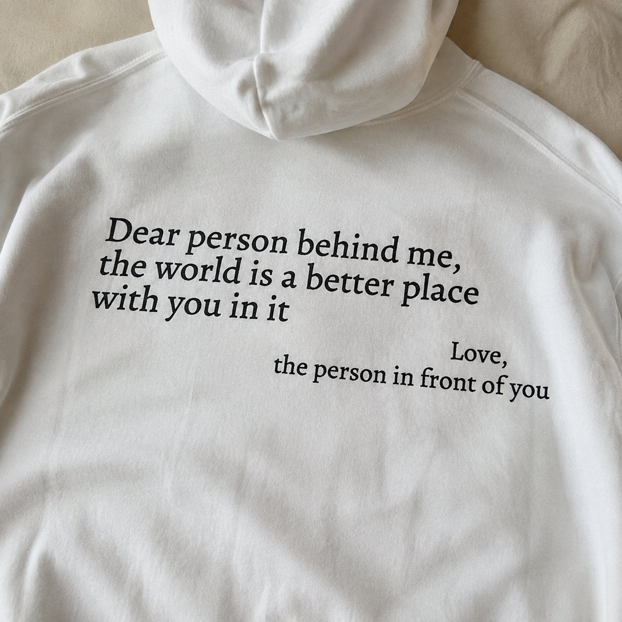Close-up of the back print on the white sweatshirt