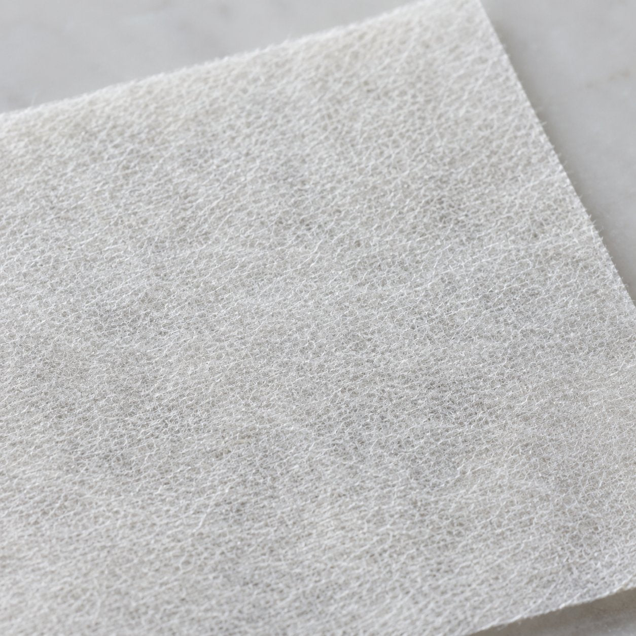 Macro close-up of the Pomence Laundry Detergent Sheet's fibrous texture