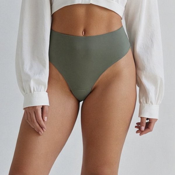 The high-rise waistband of the Pomence Invisible No-Show Thong in Moss