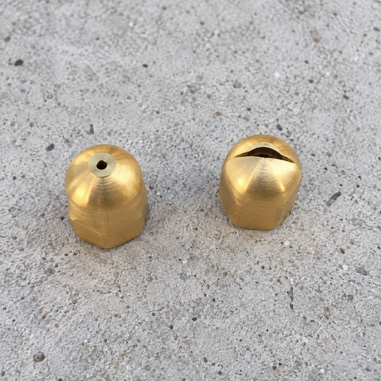 The two brass JetHose nozzle tips side by side