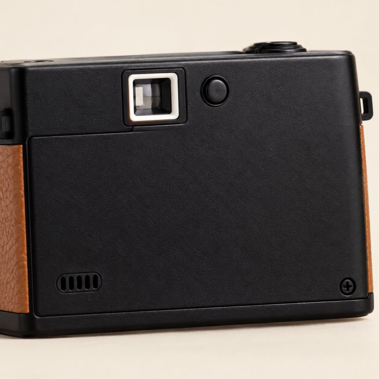 Close-up of the USB-C port on the Pomence Mini Retro Camera with a cable plugged partway in