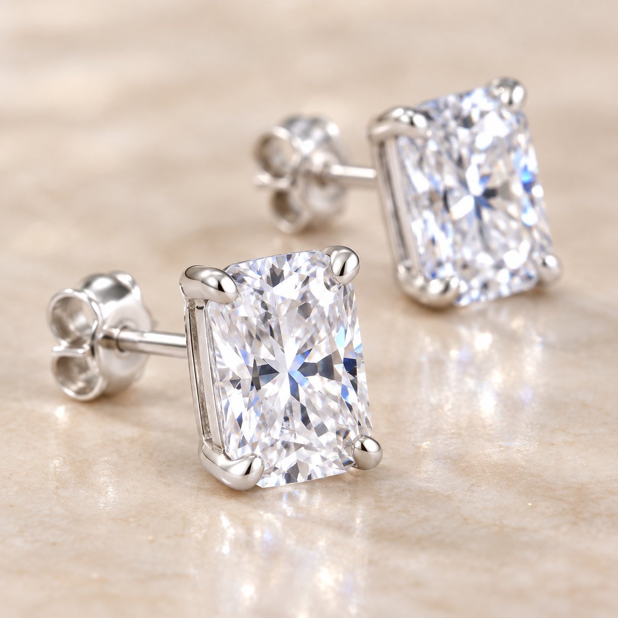 Close-up of the four-prong basket setting holding the moissanite stone on a Pomence stud earring