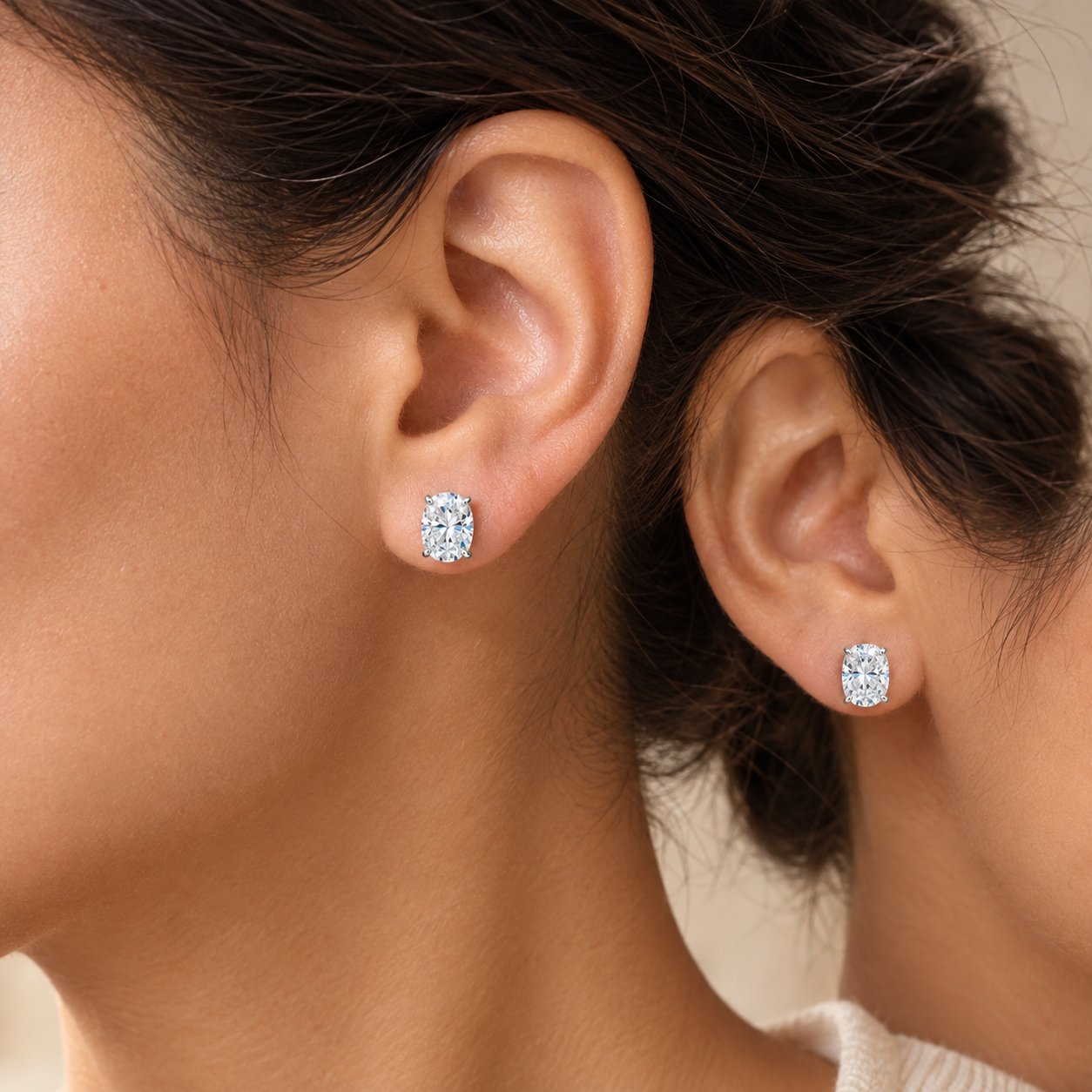 Six pairs of Pomence Moissanite Stud Earrings laid in a row showing the oval, radiant, octagon, pear, heart and marquise cuts
