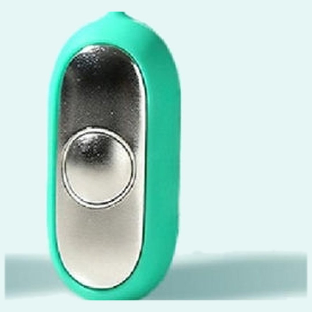 Macro of the mirror polished silver faceplate on the Pomence Palm Calm Fidget catching a moving highlight