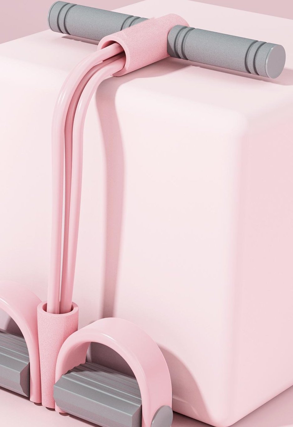 The pink Pomence Pedal Resistance Band resting against a pink block