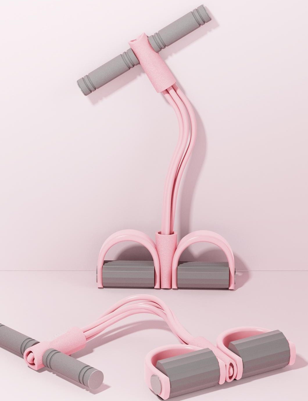 Two pink Pomence Pedal Resistance Bands, one standing and one lying on the floor