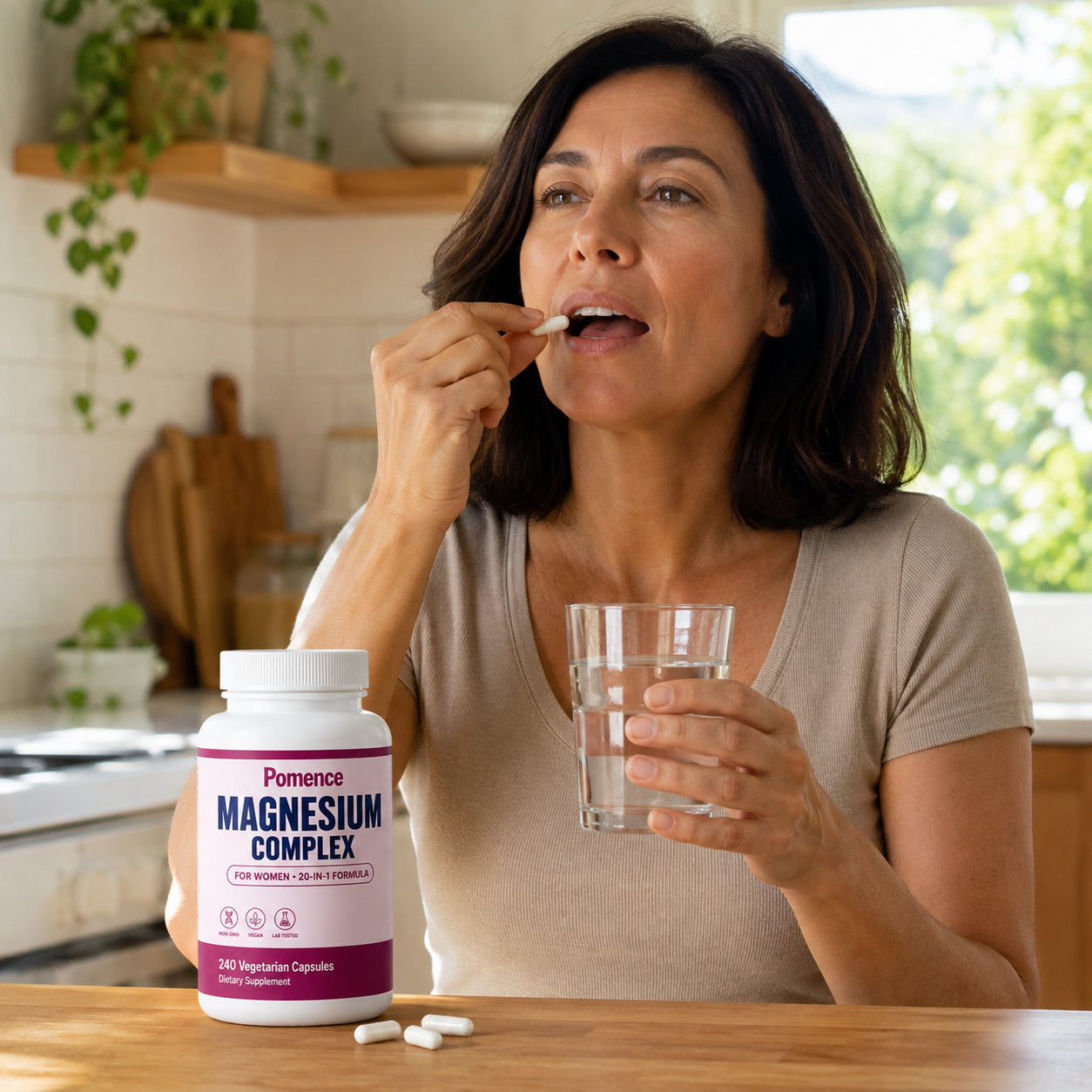 Woman taking a capsule with water in the morning