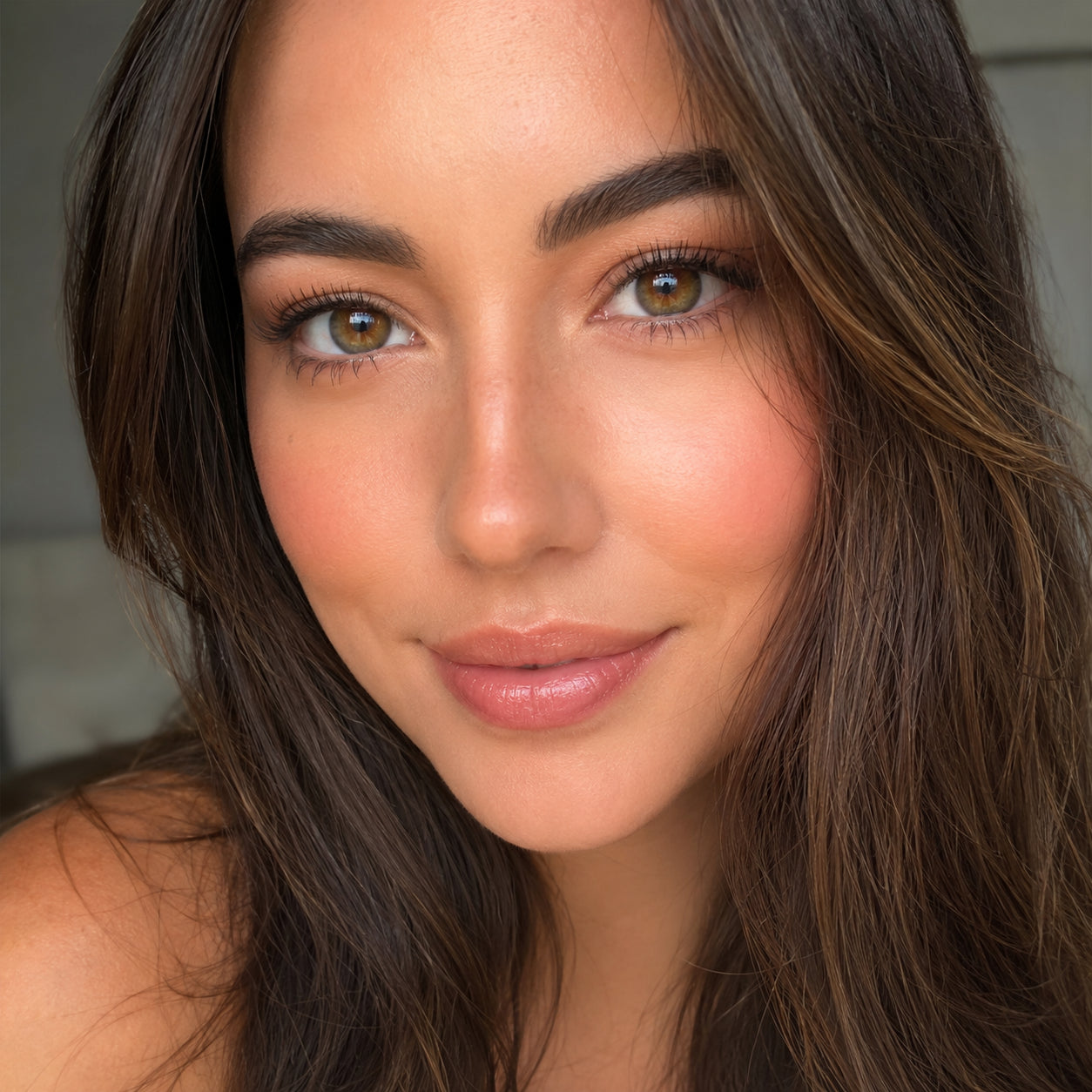 Close-up of a woman's smooth, natural-looking finished makeup
