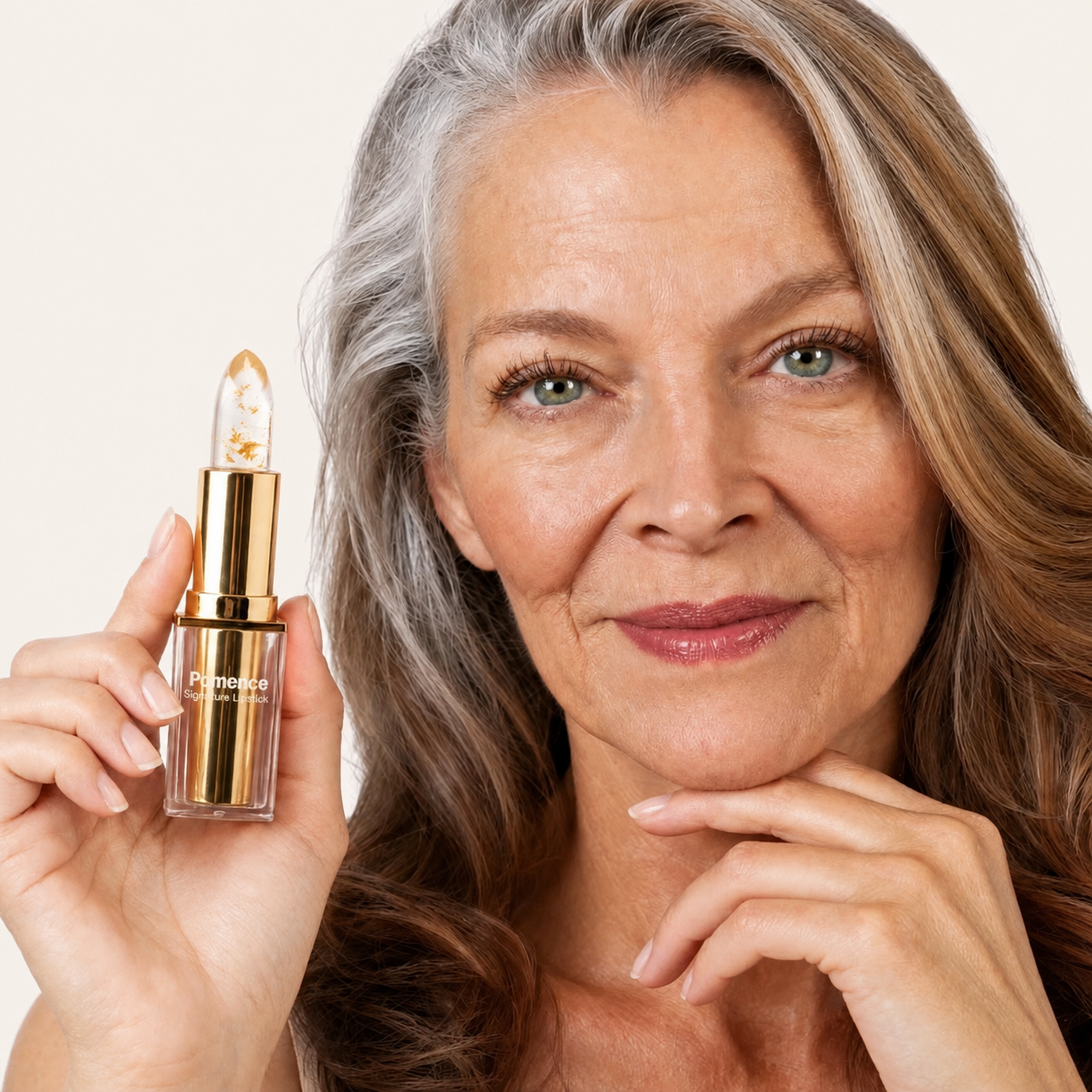 Woman smiling while holding Pomence Signature Lipstick