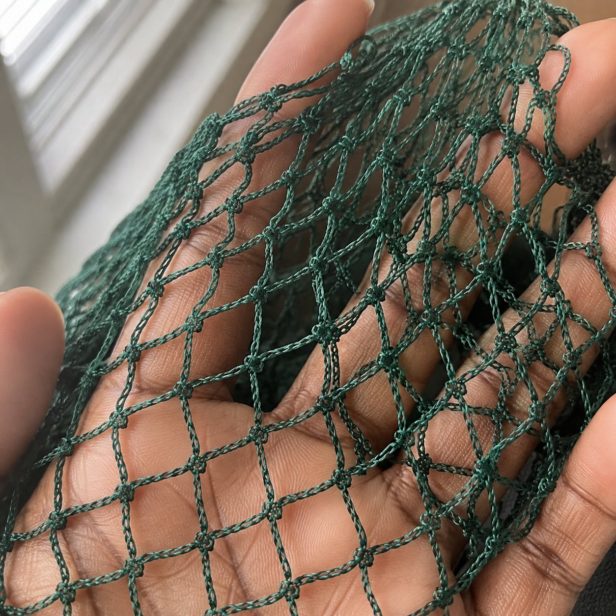 Close-up of the knotted nylon mesh weave