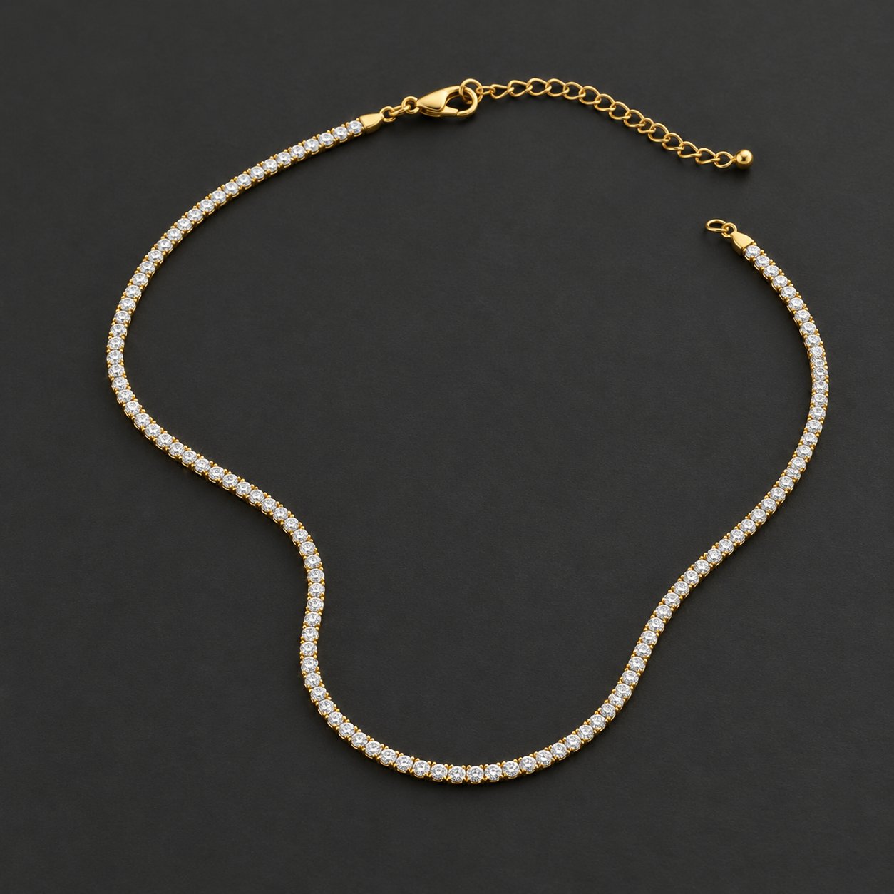The Pomence Tennis Necklace laid out alone on a plain surface