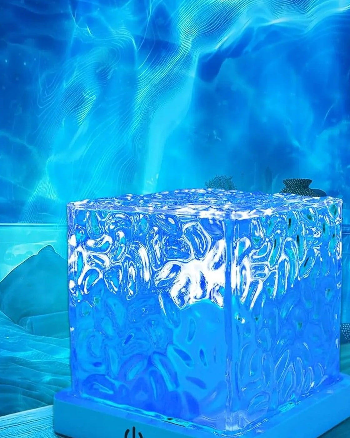 The Pomence Water Ripple Cube Lamp lighting a bedroom with blue water ripples