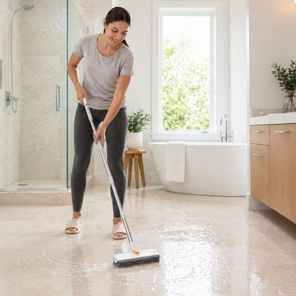 A woman scrubbing a wet bathroom floor standing up with the Pomence 3-in-1 Floor Scrub Brush
