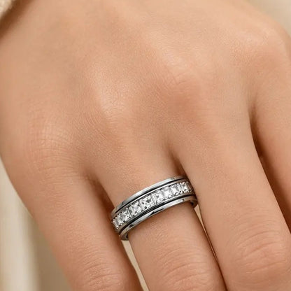 Pomence™ Anxiety Spinner Ring. Spinner ring worn on a hand against a cream knit sleeve