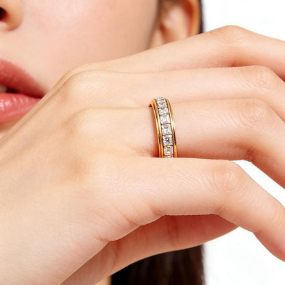 Pomence™ Anxiety Spinner Ring. Spinner ring worn on a hand held near the face
