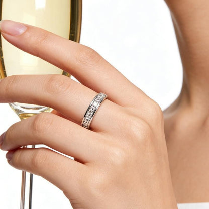 Pomence™ Anxiety Spinner Ring. Spinner ring worn on a hand holding a glass