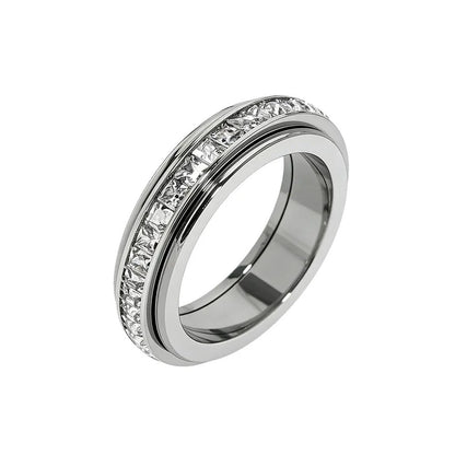 Pomence™ Anxiety Spinner Ring. Spinner ring standing on its edge on a white background