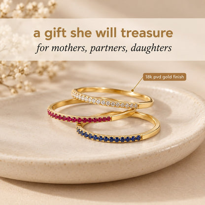 Three Pomence Birthstone Stacking Rings in different birth month colors staged together as a gift