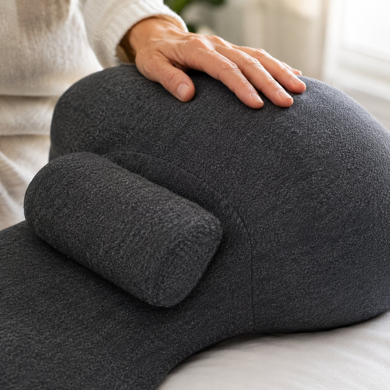 Close-up of the curved wedge shape and knit fabric of the Pomence Couples Comfort Pillow