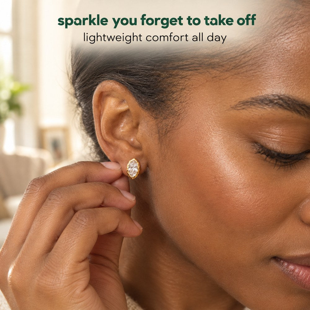 A woman wearing the Pomence Crystal Mini Stud Earrings in clear crystal, close on the ear