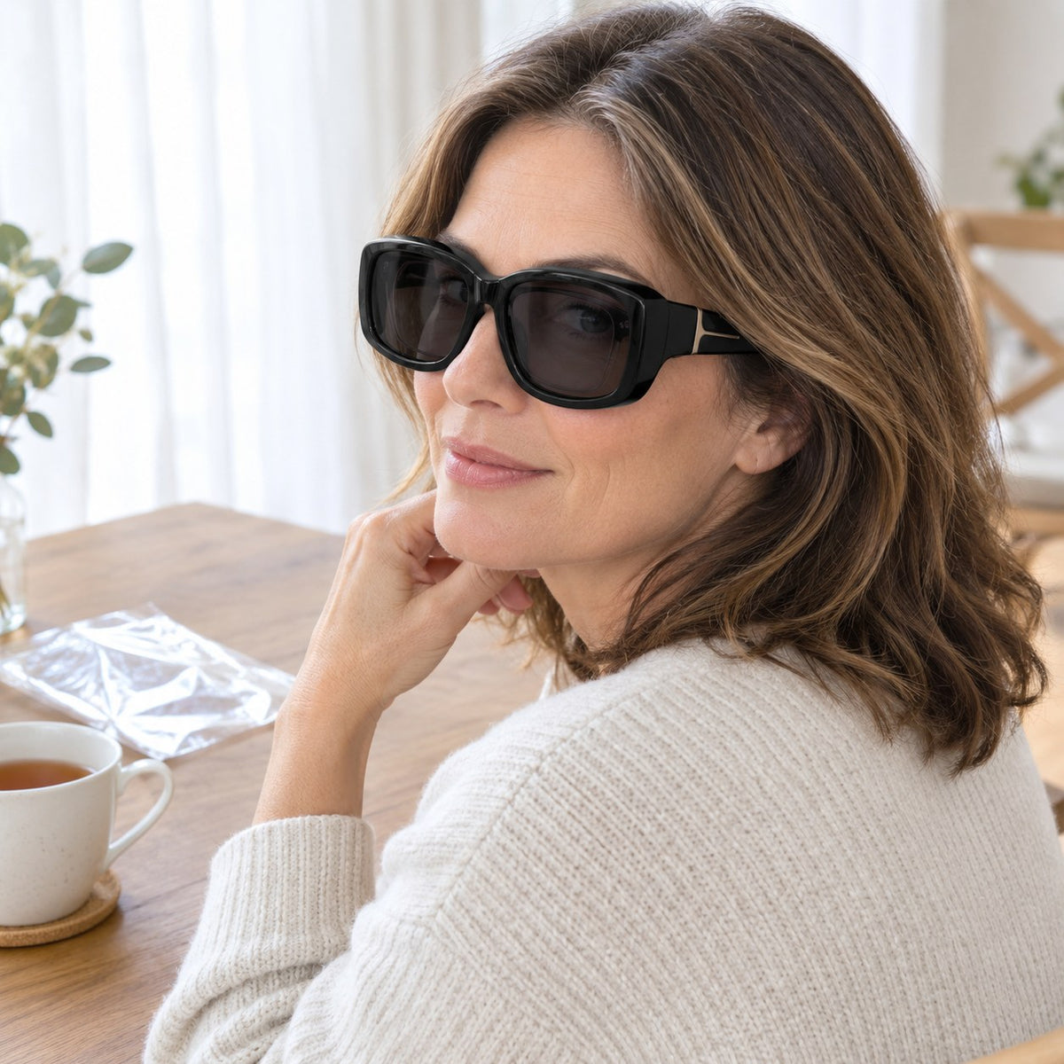 Pomence Fit-Over Sunglasses on a table beside the clear bag they arrive in