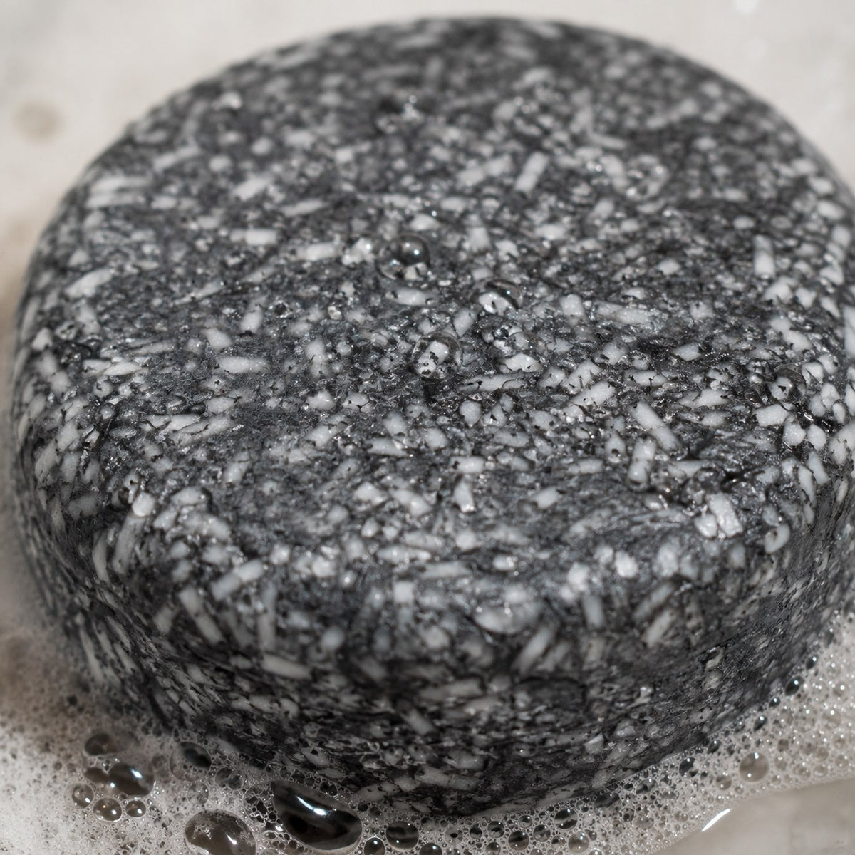Macro close-up of the bamboo charcoal texture in the soap bar
