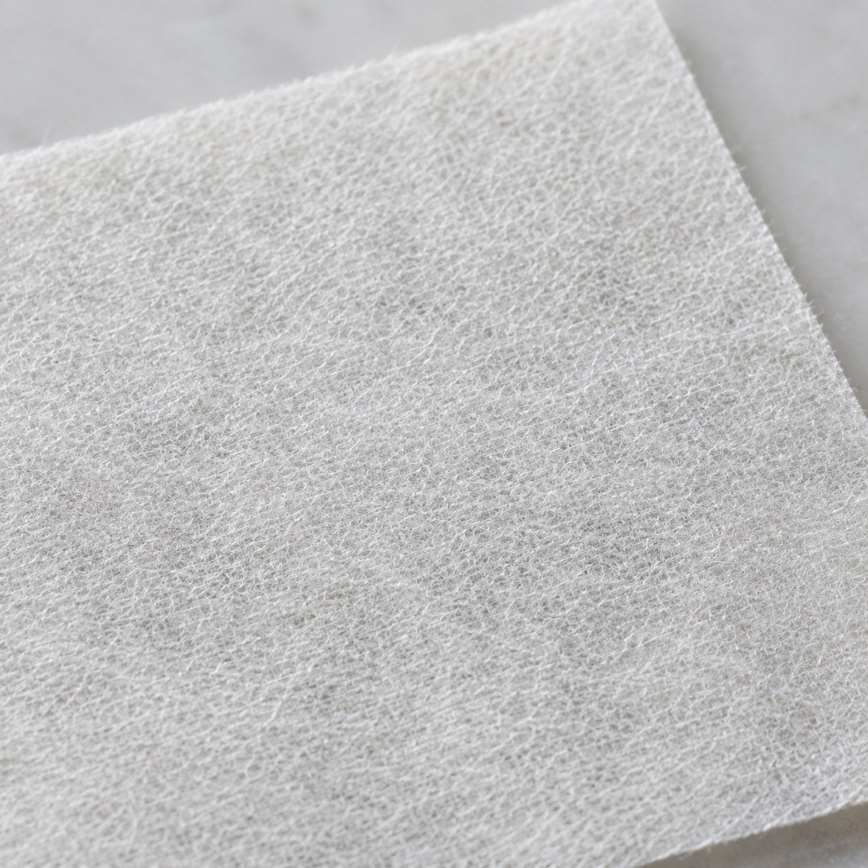 Macro close-up of the Pomence Laundry Detergent Sheet's fibrous texture