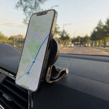 Pomence™ Magnetic Car Phone Mount. Clipped onto a car dashboard, phone attached showing a maps navigation screen