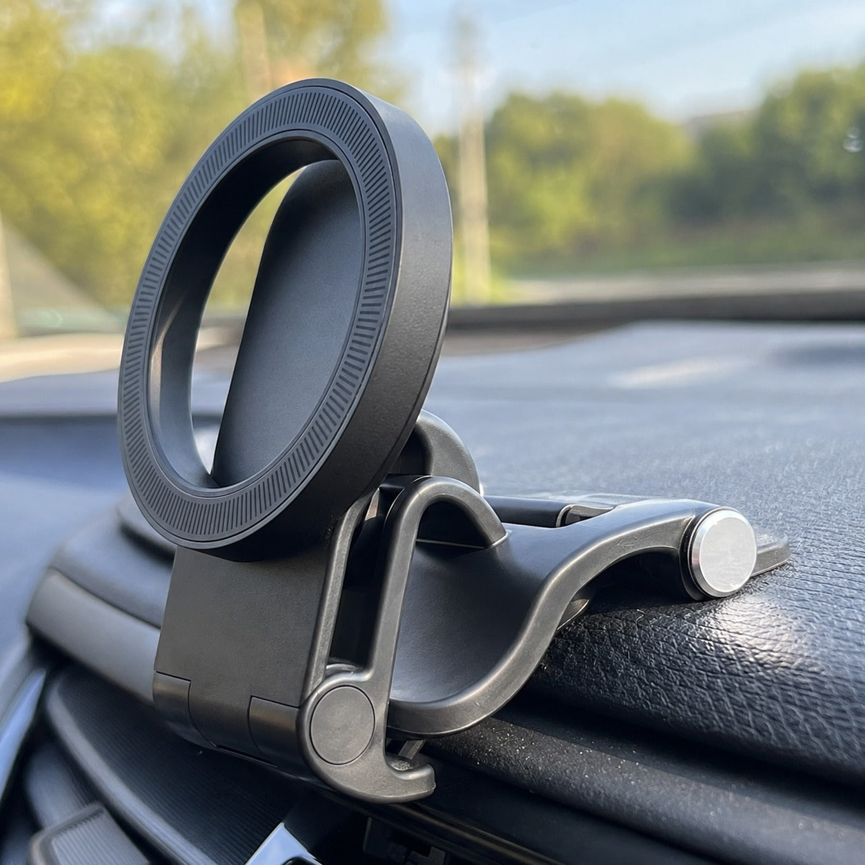 Pomence™ Magnetic Car Phone Mount. Close-up of the spring clip gripping the edge of a car dashboard