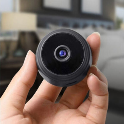 Close-up of the Pomence Mini WiFi Security Camera held in a hand, showing its compact size