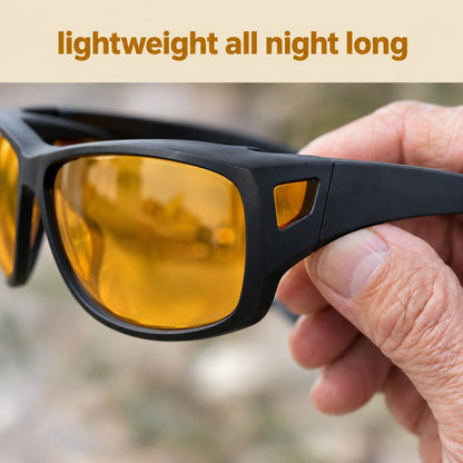 The Pomence Night Driving Glasses held in one hand, showing the wide flat matte black arm and the amber side window at the temple