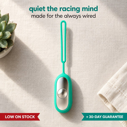 Palm Calm Fidget in Teal on pale linen: mirror polished silver metal faceplate with one domed button and the silicone loop complete