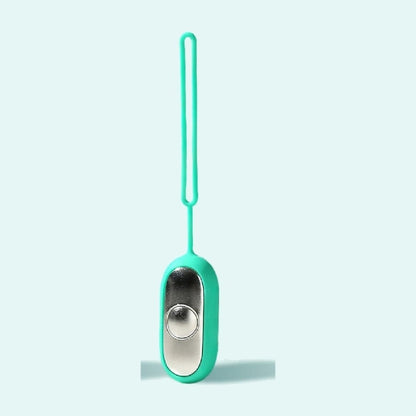 The Teal Palm Calm Fidget alone: mirror polished silver metal faceplate, one domed button, soft matte silicone shell and the long silicone loop