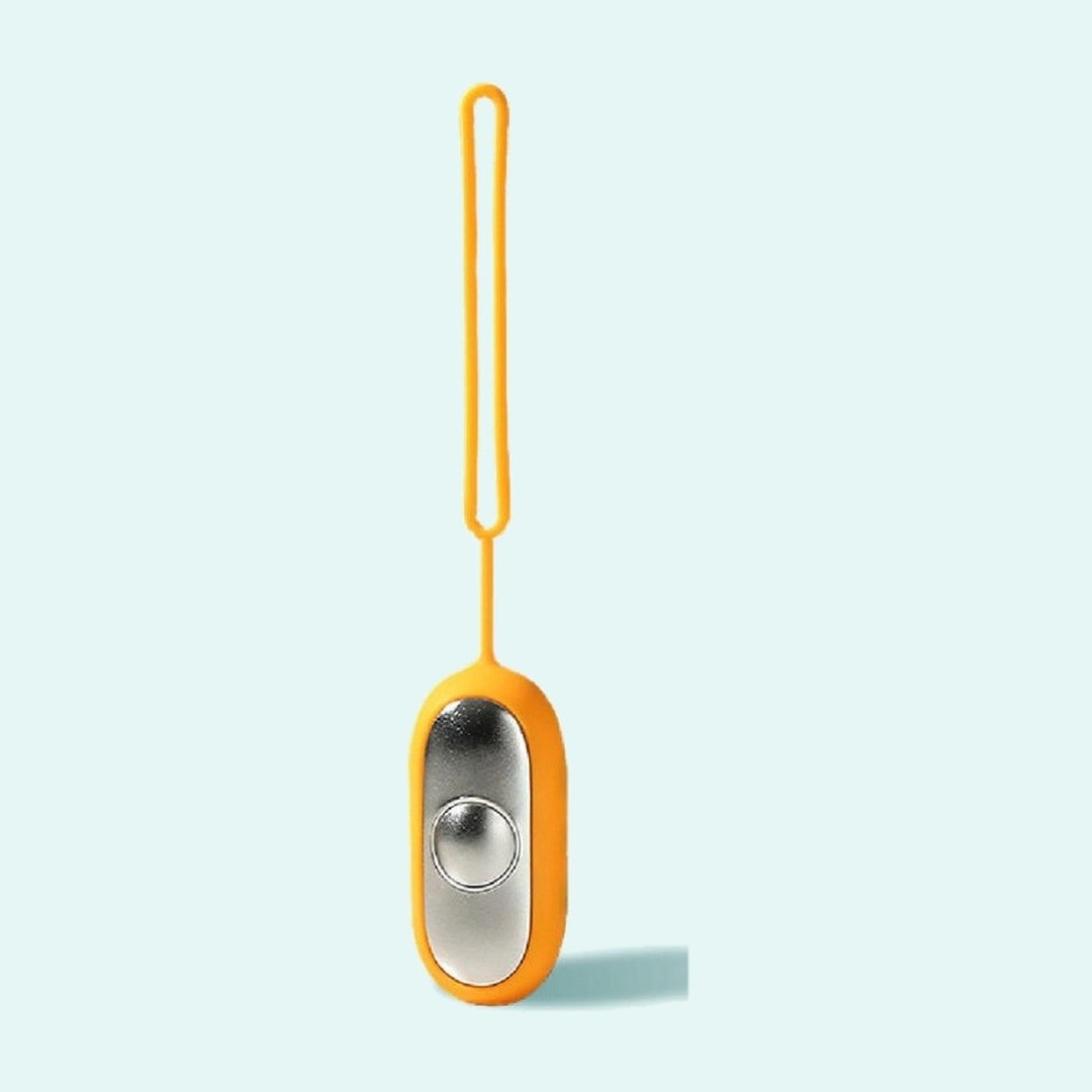 Palm Calm Fidget in Orange: mirror polished silver faceplate, one domed button, orange silicone shell and loop