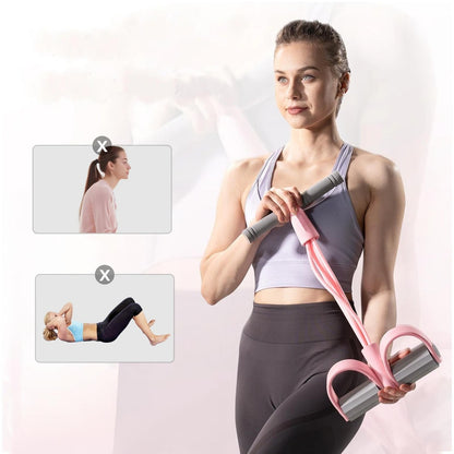 A woman holding the pink Pomence Pedal Resistance Band by its foam handles with the foot pedals at her hip