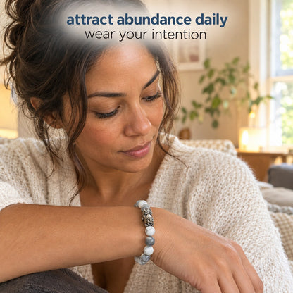 A woman wearing the Pomence Pixiu Wealth Bracelet at home, the Pixiu charm on the top of her wrist