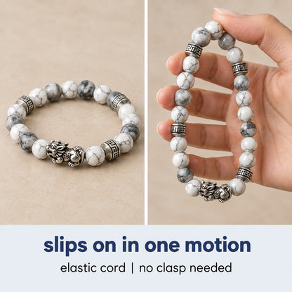 The Pomence Pixiu Wealth Bracelet coiled and then stretched open, showing the elastic cord and the no-clasp fit