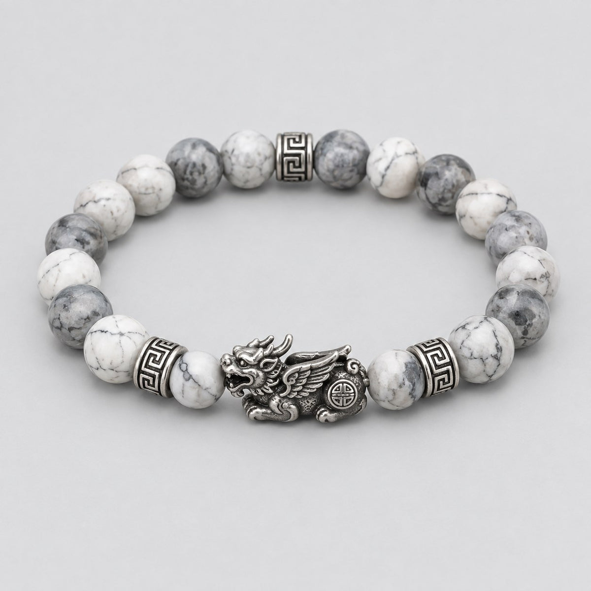 The Pomence Pixiu Wealth Bracelet alone on a plain pale grey background, coiled with the Pixiu charm at the front