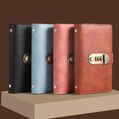 Four Pomence Savings Binders standing in a row in black, blue, pink and brown