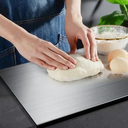 Pomence™ Stainless Steel Chopping Board. Hands kneading bread dough straight on the steel surface