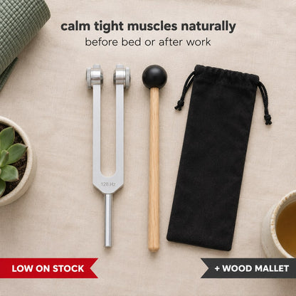 The Pomence 128 Hz Weighted Tuning Fork and its wooden mallet laid flat, with the headline calm tight muscles naturally