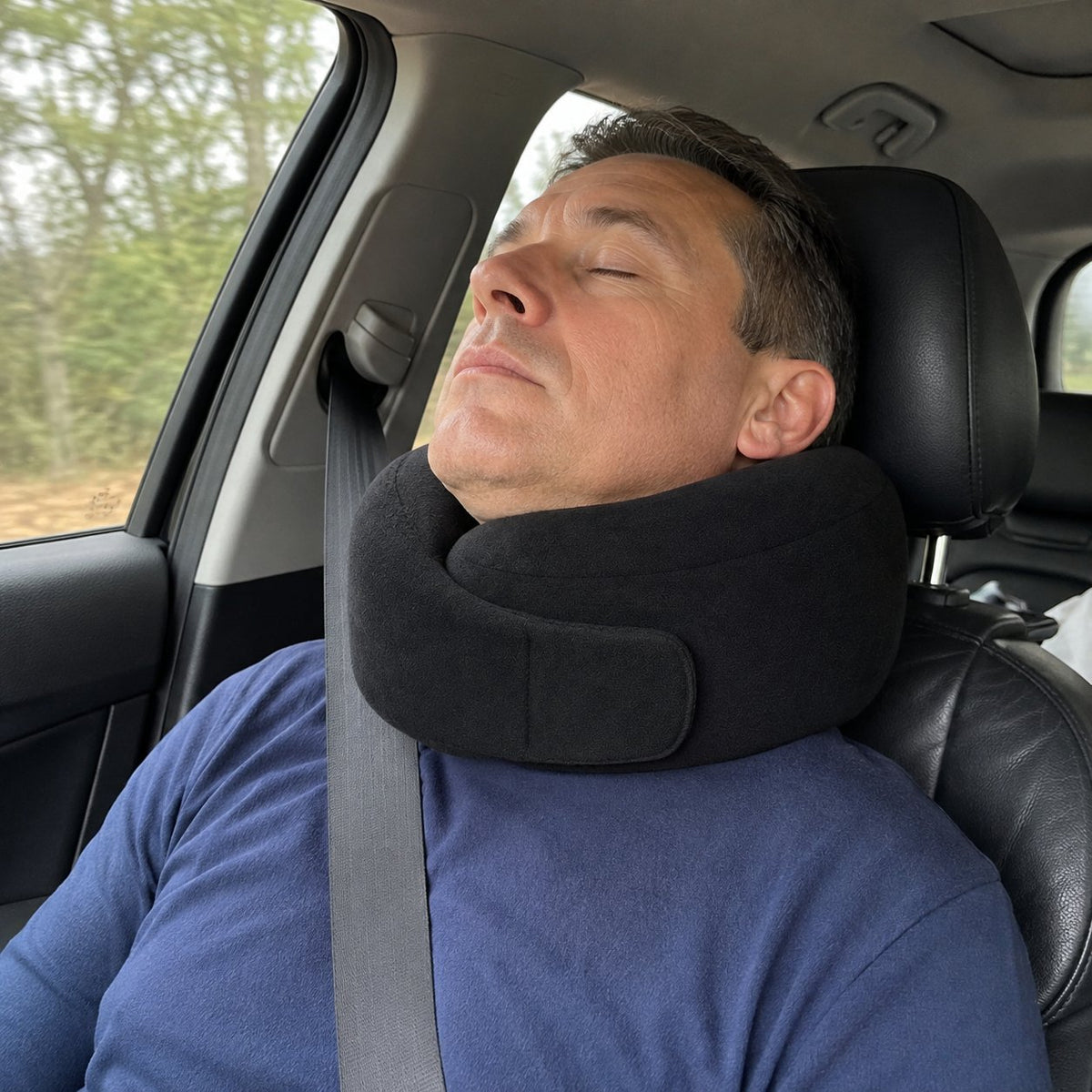 Pomence™ Wrap Travel Neck Pillow. Worn dozing in a car passenger seat, chin supported