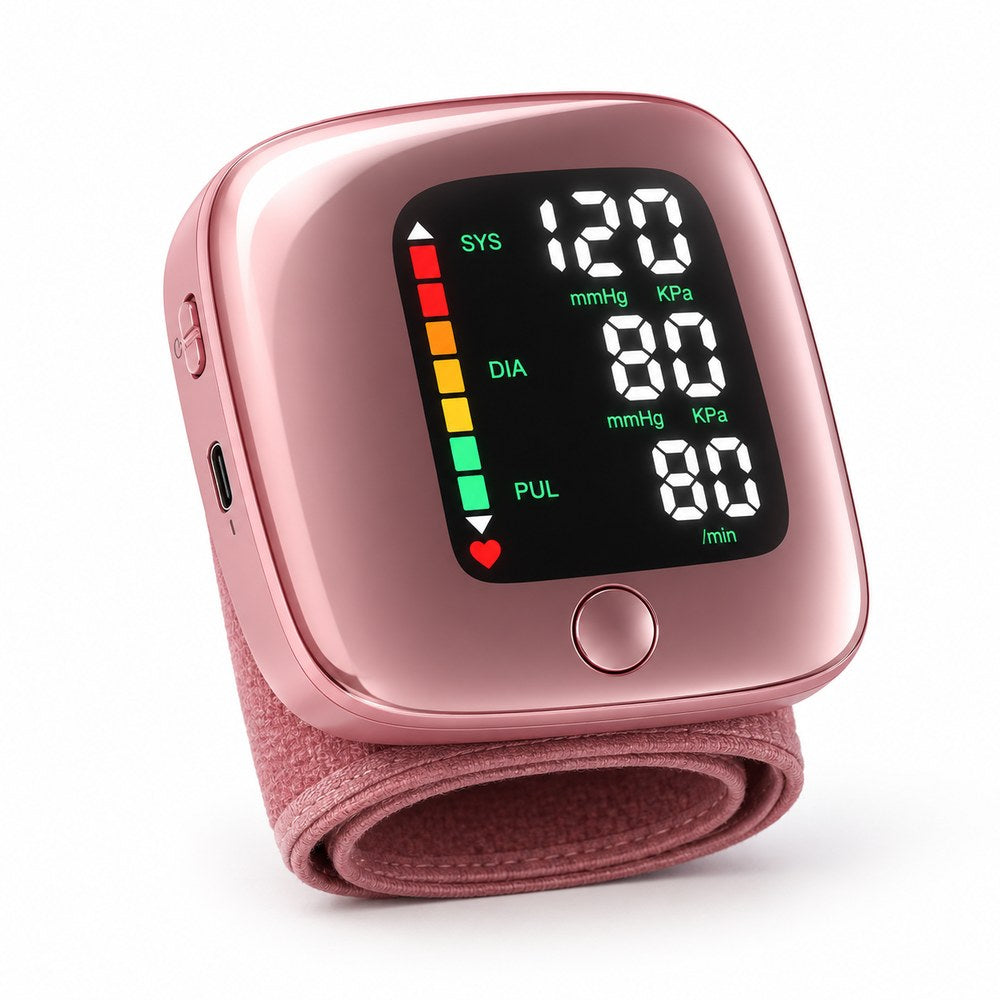 Pomence Wrist Blood Pressure Monitor in pink: the same unit with a rose-pink mirror shell and a pink fabric wrist band