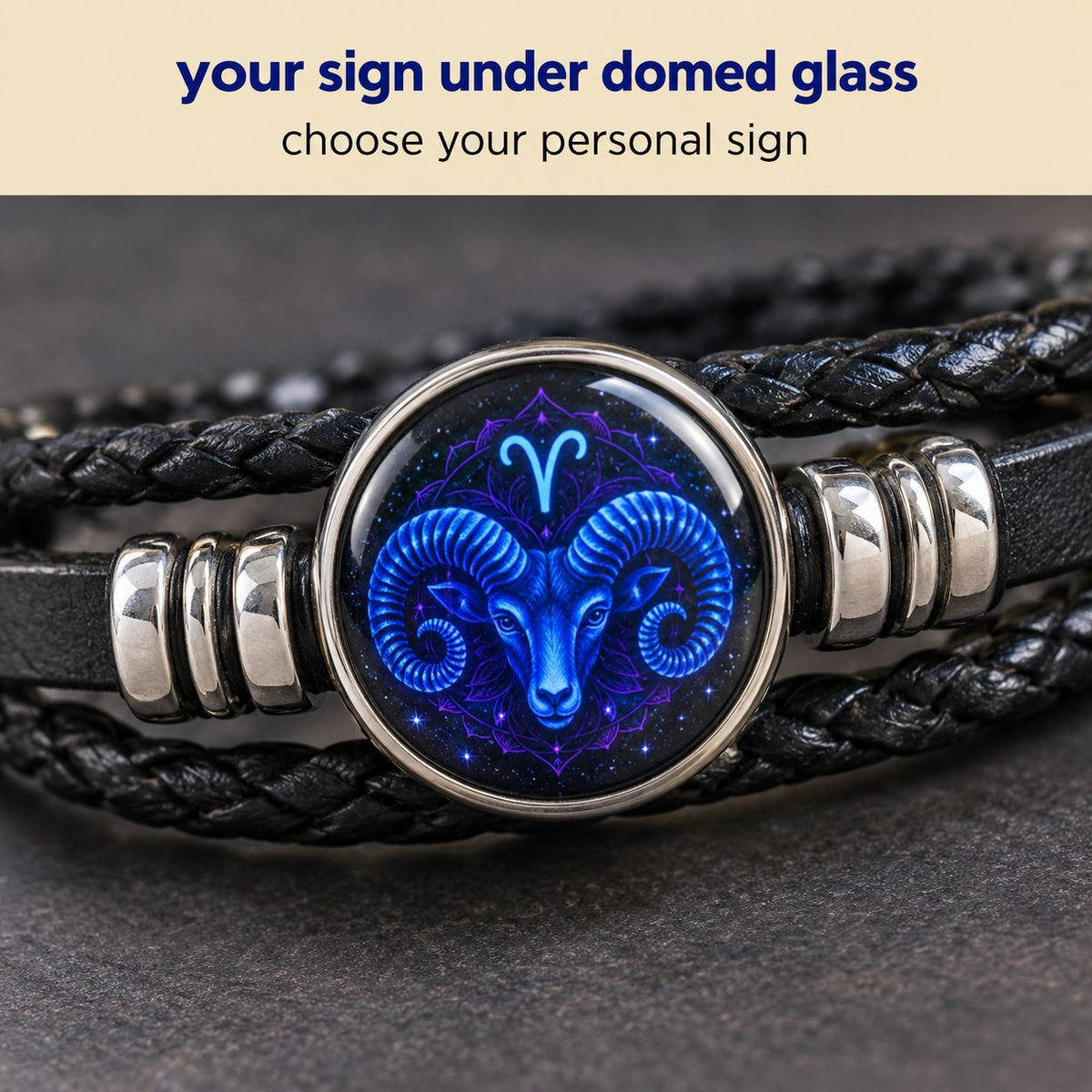Macro of the glass zodiac dome on the Pomence Zodiac Leather Bracelet, captioned twelve zodiac signs available